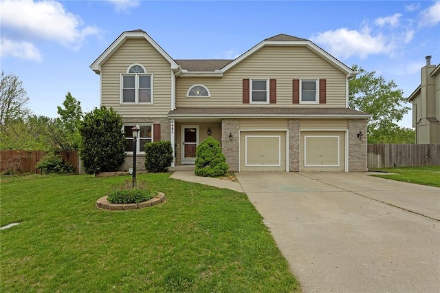 traditional-style home with concrete driveway, an attached garage, fence, and a front yard