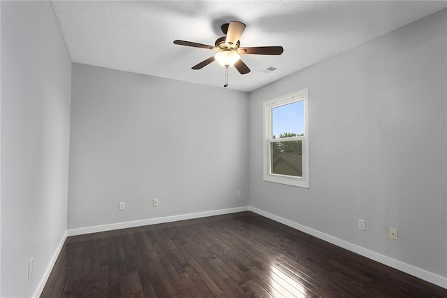 unfurnished room featuring visible vents, baseboards, a textured ceiling, a ceiling fan, and dark wood finished floors