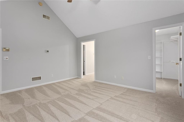 spare room with baseboards, ceiling fan, light carpet, and visible vents