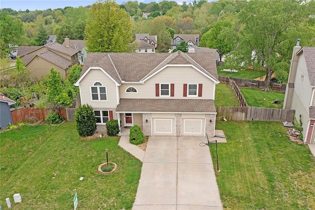 traditional-style home with a shingled roof, an attached garage, brick siding, fence private yard, and driveway