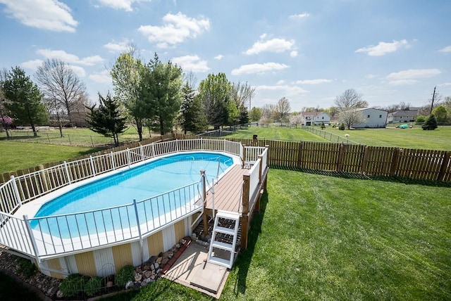 view of swimming pool featuring a fenced in pool, a fenced backyard, and a lawn