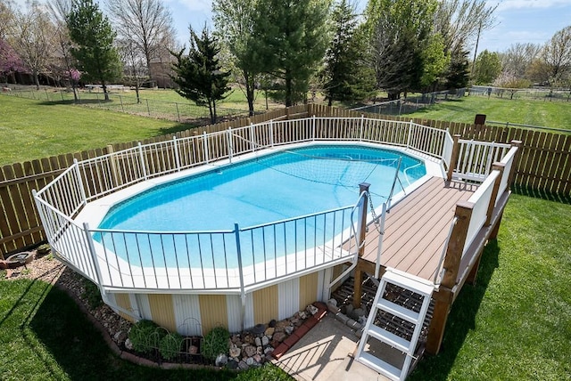 view of swimming pool featuring a fenced in pool, a yard, and a fenced backyard