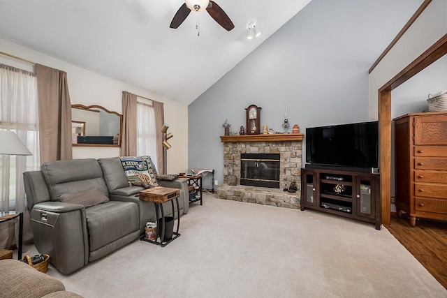 living room with high vaulted ceiling, ceiling fan, and a fireplace