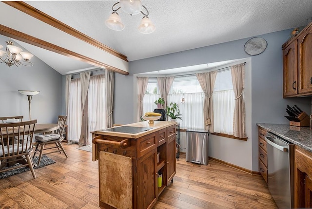 kitchen with an inviting chandelier, dishwasher, a textured ceiling, brown cabinetry, and light wood finished floors