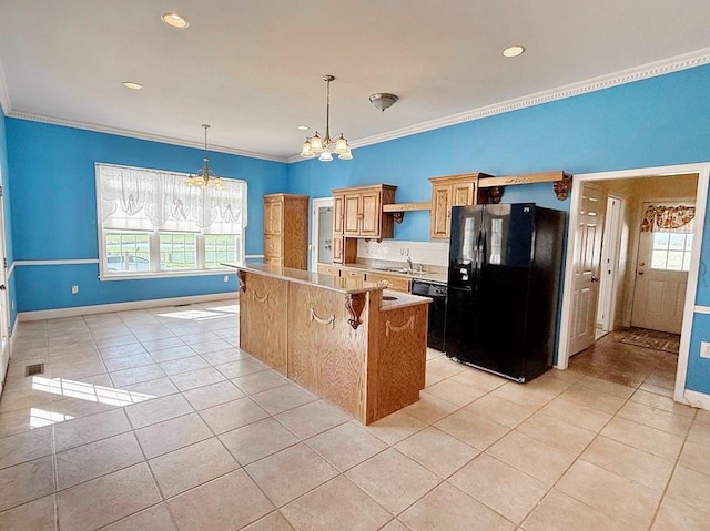 kitchen featuring light tile patterned floors, ornamental molding, black appliances, a chandelier, and a sink