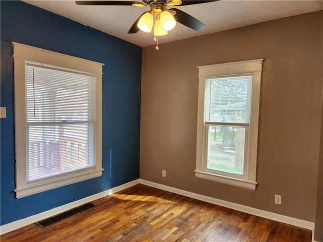 1126 S Pearl St, Independence, MO 64050 - empty room with wood finished floors, baseboards, ceiling fan, and visible vents
