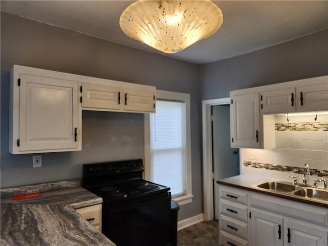 1126 S Pearl St, Independence, MO 64050 - kitchen featuring white cabinets, decorative backsplash, a sink, and black / electric stove