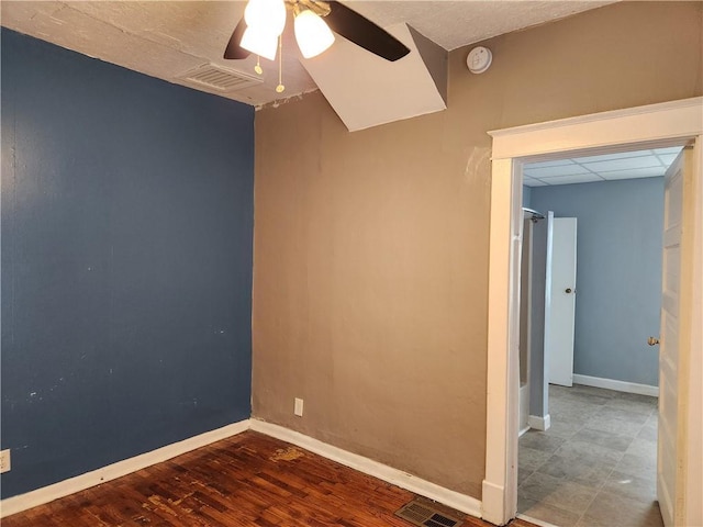 1126 S Pearl St, Independence, MO 64050 - empty room with a ceiling fan, wood finished floors, baseboards, and visible vents
