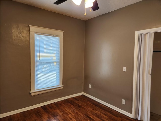 1126 S Pearl St, Independence, MO 64050 - unfurnished room with dark wood-style flooring, baseboards, and ceiling fan