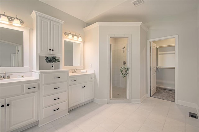 full bathroom with vanity, a shower stall, lofted ceiling, and visible vents