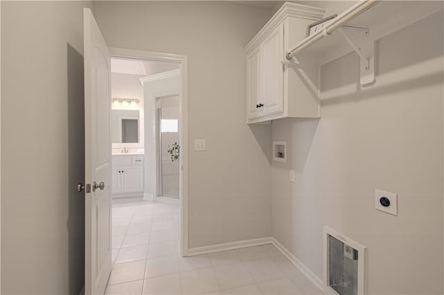 washroom with hookup for a washing machine, baseboards, light tile patterned flooring, cabinet space, and electric dryer hookup