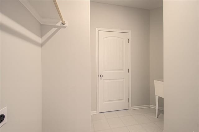 clothes washing area featuring baseboards and laundry area