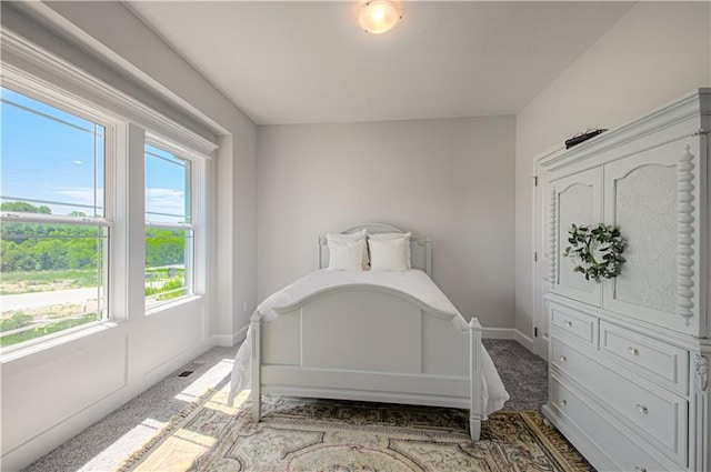 carpeted bedroom with baseboards and visible vents