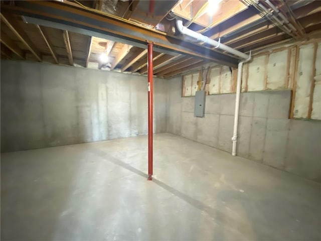 unfinished basement featuring electric panel