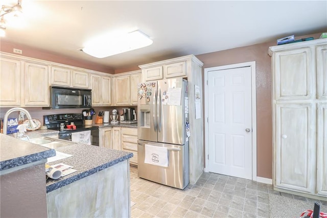 1404 S Market St, Holden, MO 64040 - kitchen featuring black appliances, a sink, and baseboards