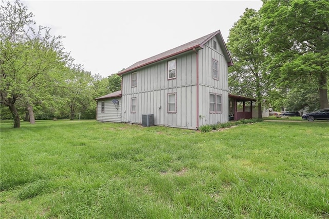 1404 S Market St, Holden, MO 64040 - view of side of property featuring board and batten siding, central AC, and a yard