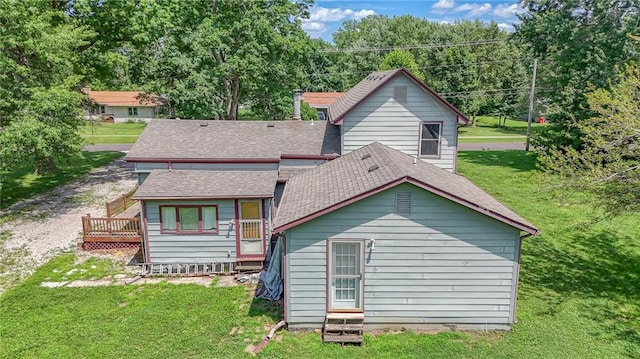 1404 S Market St, Holden, MO 64040 - rear view of house featuring a lawn, a shingled roof, and a deck