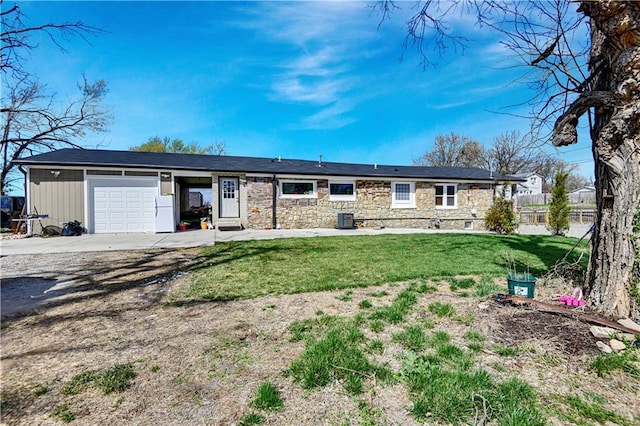 2705 Endicott Ave, Kansas City, KS 66104 - ranch-style home featuring cooling unit, an attached garage, stone siding, driveway, and a front lawn