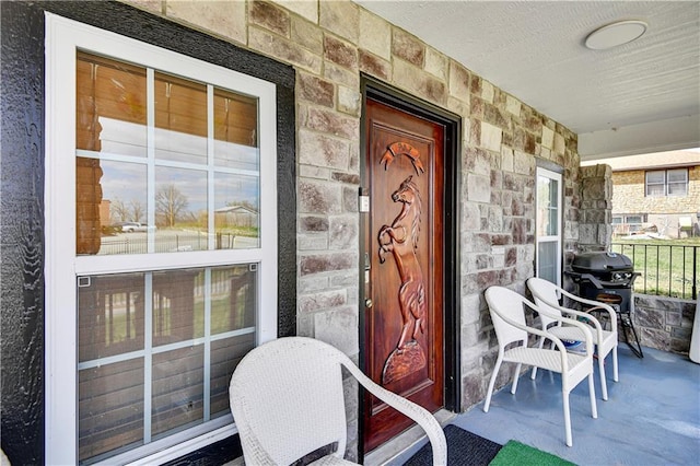 2705 Endicott Ave, Kansas City, KS 66104 - view of exterior entry with stone siding and a porch