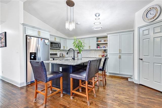 2705 Endicott Ave, Kansas City, KS 66104 - kitchen with vaulted ceiling, open shelves, dark wood-style flooring, stainless steel appliances, and light stone countertops