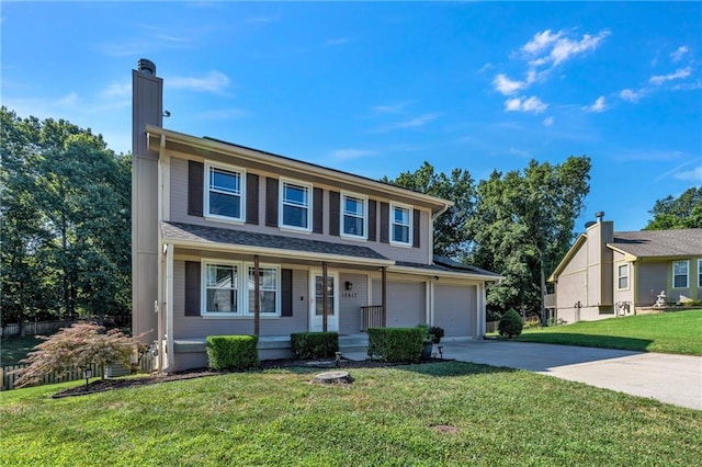 view of front of house with driveway, an attached garage, a chimney, and a front lawn