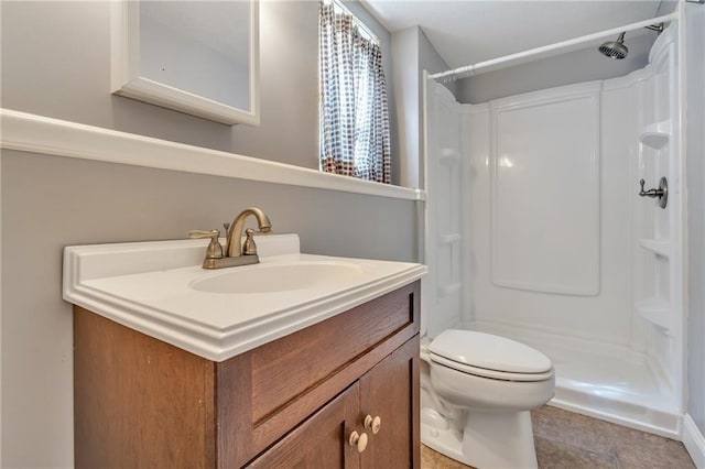 full bathroom with toilet, vanity, and walk in shower