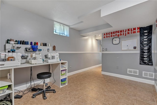 unfurnished office with baseboards and visible vents