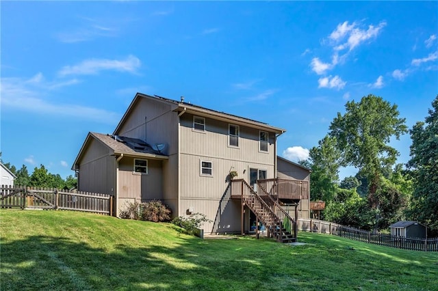 rear view of property with a wooden deck, a fenced backyard, stairs, and a lawn