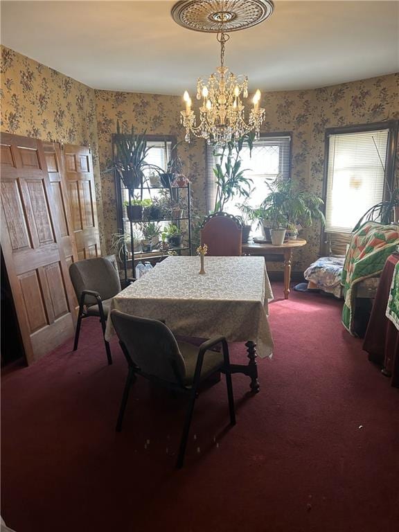 carpeted dining area featuring wallpapered walls and a notable chandelier