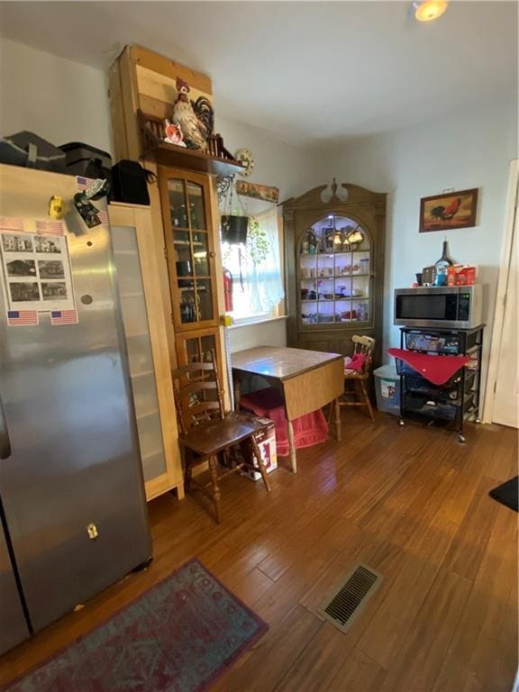 dining area with wood finished floors and visible vents