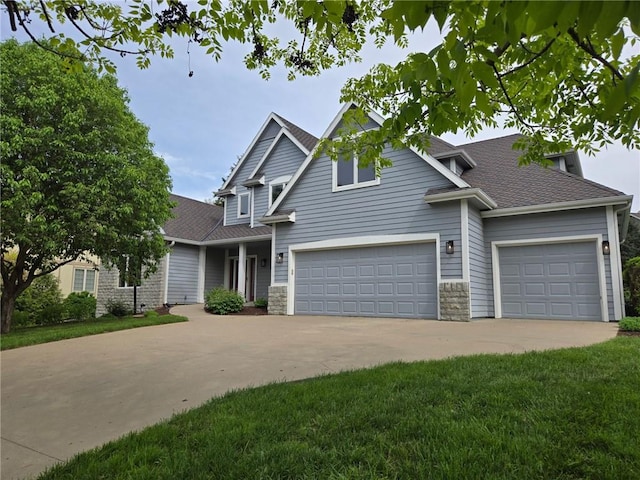 view of front facade with a garage, a shingled roof, stone siding, and concrete driveway
