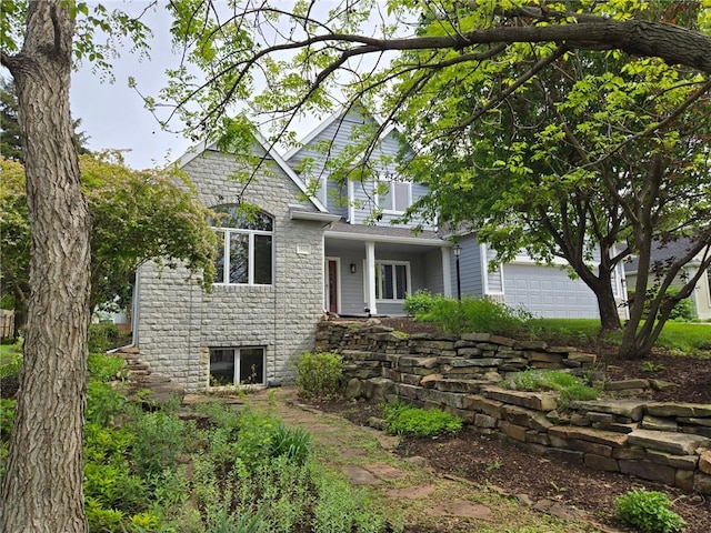 view of front of house featuring stone siding and a garage