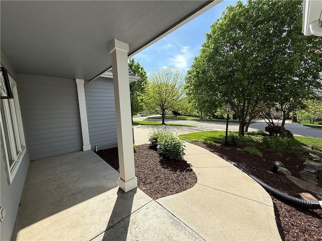 view of patio with an AC wall unit