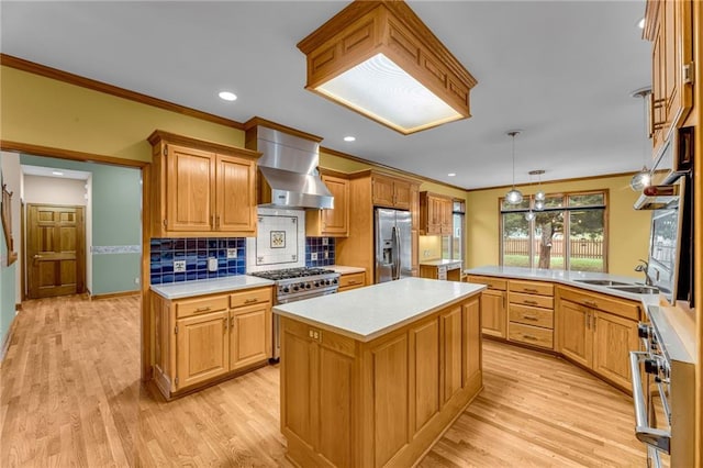 kitchen featuring wall chimney range hood, crown molding, light wood-style floors, and stainless steel appliances