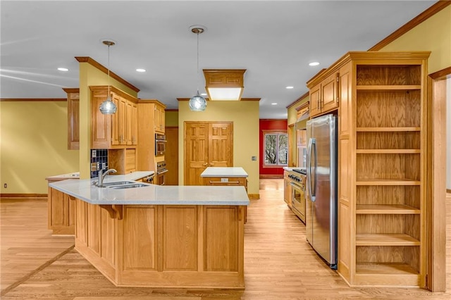 kitchen with a center island, open shelves, a sink, freestanding refrigerator, and a peninsula
