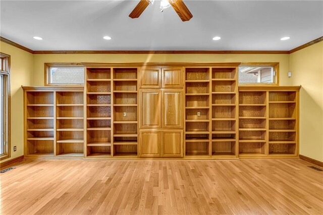 interior space with crown molding, baseboards, light wood finished floors, and a wealth of natural light