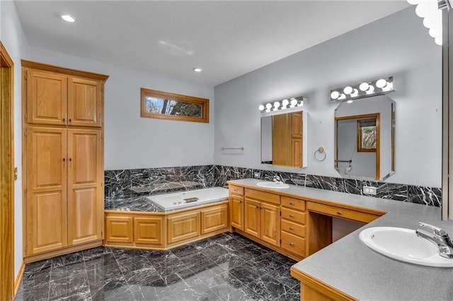 bathroom with a sink, a garden tub, double vanity, and marble finish floor