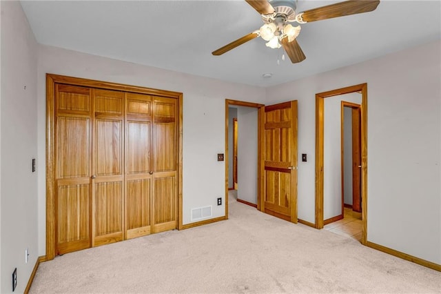 unfurnished bedroom with ceiling fan, carpet, baseboards, visible vents, and a closet