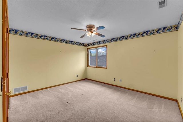 unfurnished room with visible vents, a ceiling fan, baseboards, and carpet floors