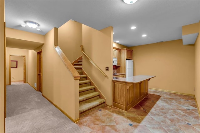 interior space with baseboards and recessed lighting