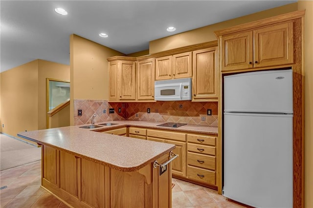 kitchen featuring white appliances, recessed lighting, tasteful backsplash, and light countertops