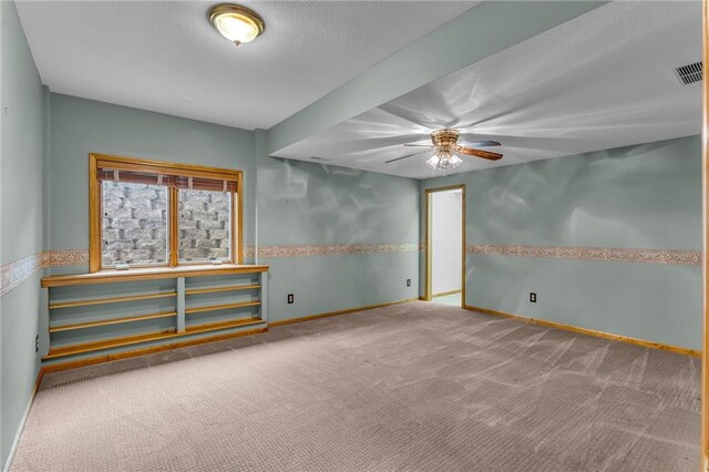 unfurnished room with a ceiling fan, baseboards, visible vents, and carpet