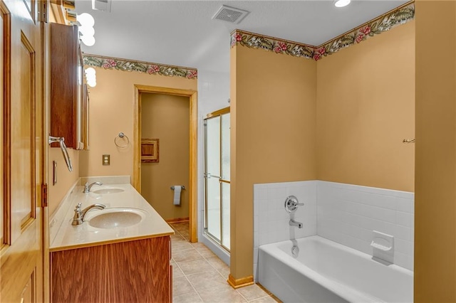 full bath with visible vents, a sink, a garden tub, and tile patterned floors