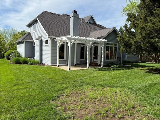 rear view of property featuring a chimney, a patio area, a yard, a pergola, and a shingled roof