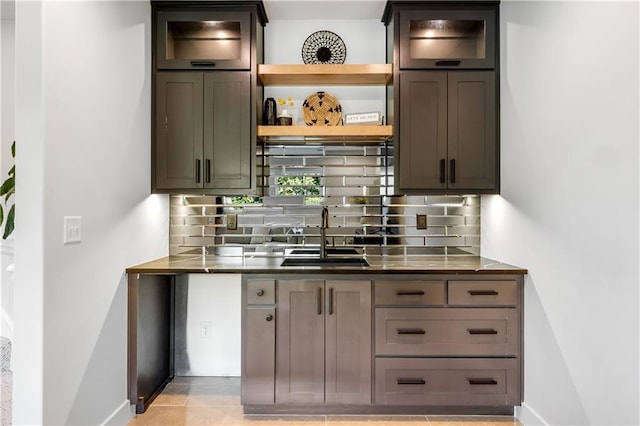 3208 SW Saddlebred Ter, Lees Summit, MO 64082 - kitchen featuring a sink, open shelves, decorative backsplash, and baseboards