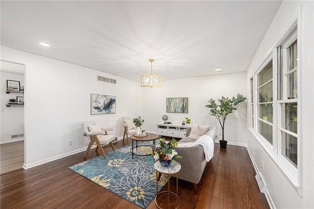 living area with dark wood finished floors, a chandelier, baseboards, and recessed lighting