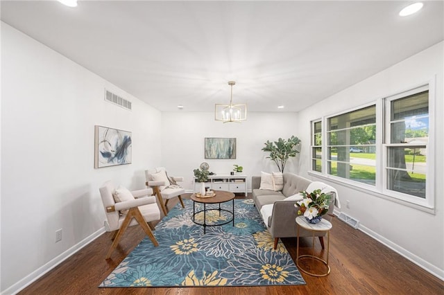 living room with wood finished floors, baseboards, a chandelier, and recessed lighting