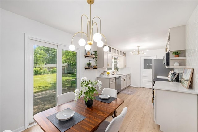 dining space featuring a chandelier and light wood finished floors