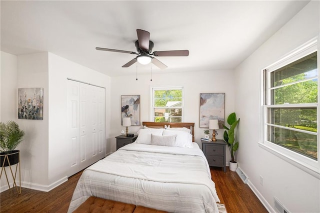 bedroom with wood finished floors, a closet, baseboards, and ceiling fan