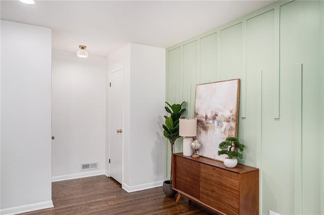 hall featuring wood finished floors, baseboards, and recessed lighting